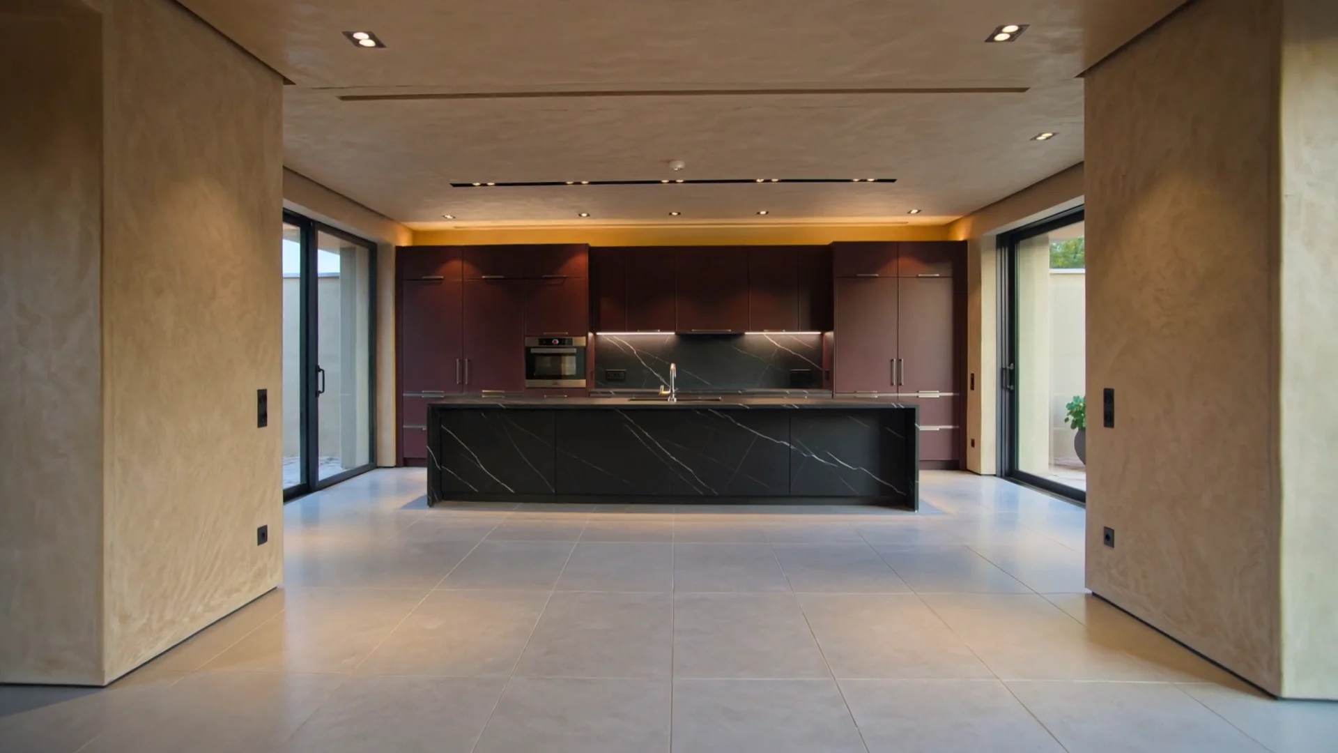 Luxury burgundy kitchen with bespoke cabinetry, black marble island and integrated appliances