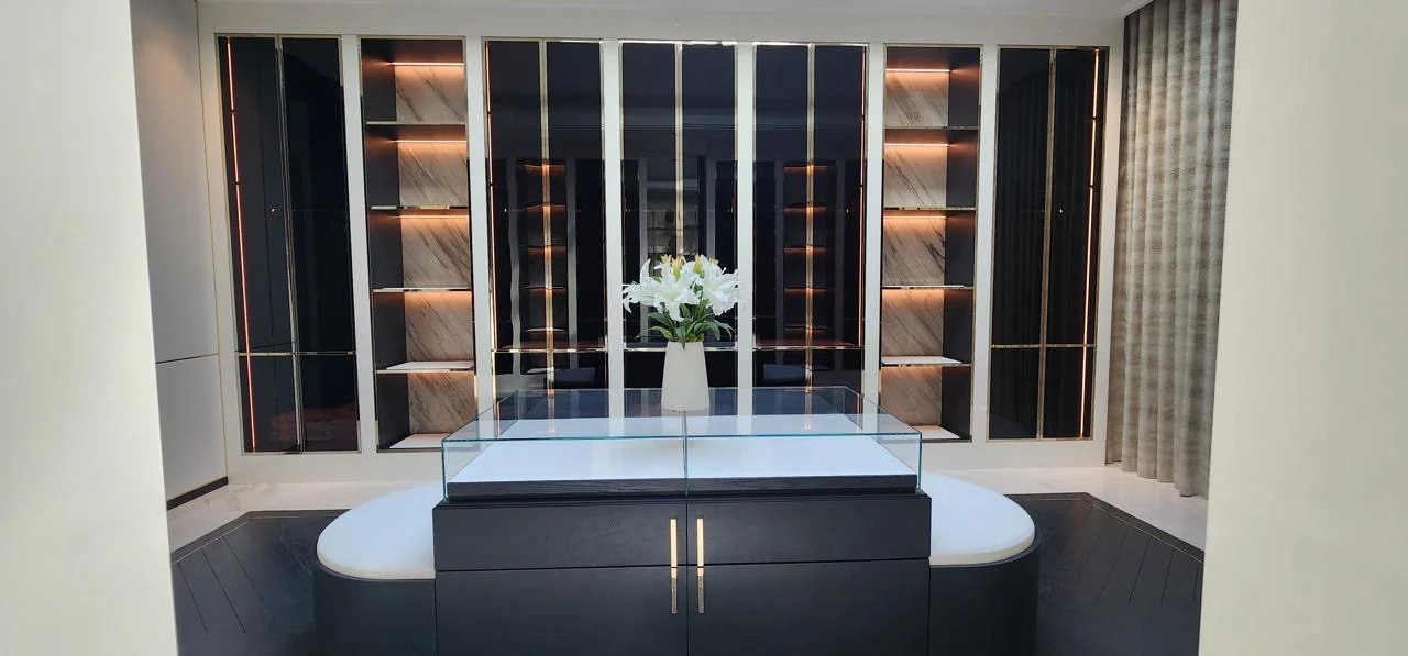 Walk-in wardrobe with central dressing island built by Time Furniture in a Jumeirah Islands villa