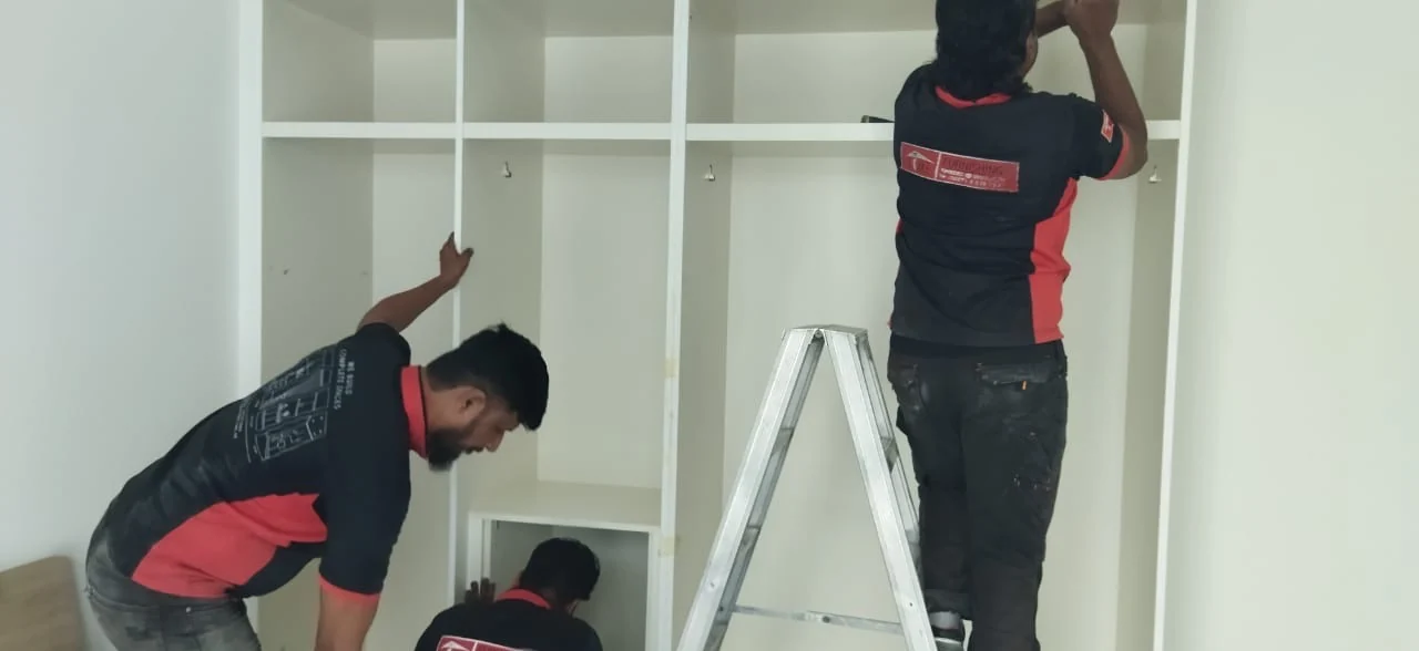 Time Furniture joinery team installing fitted wardrobe cabinetry