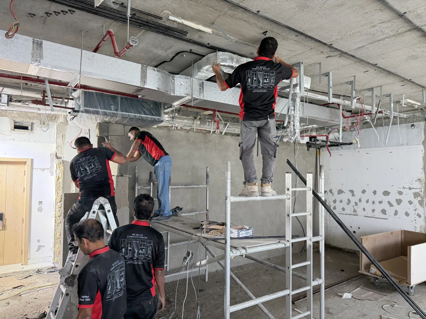 Time Furniture team coordinating ceiling services during an interior fit-out