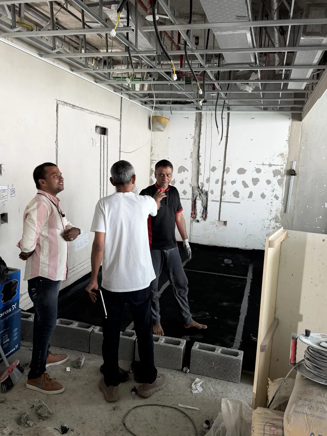 On-site discussion and project coordination during a Time Furniture fit-out